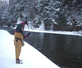 Fishing guide Randy Jones is playing a steelhead with spin or fly rod up side down - tip.