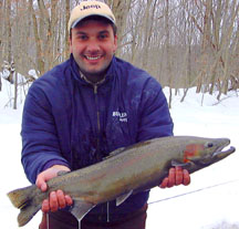 Garry lands a nice Salmon River NY Steelhead while being guided off the drift boat.