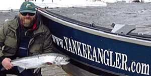 Salmon River Drift Boat guides fishing for Steelhead in Pulaski NY. My Salmon River fishing guest shows off a nice steelhead by the drift boat.