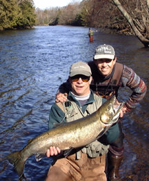 Ron lands this 17.5 pound beautiful male steelhead with help from this fishing guide.