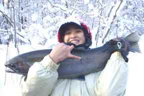 Theresa lands a 16 lb. Salmon River NY Steelhead from the salmon river guide blog drift boat!